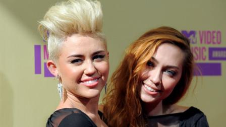 Miley Cyrus and her sister Brandi Cyrus attend the MTV Video Music Awards on Thursday, Sept. 6, 2012, in Los Angeles. (Photo by Jordan Strauss/Invision/AP)