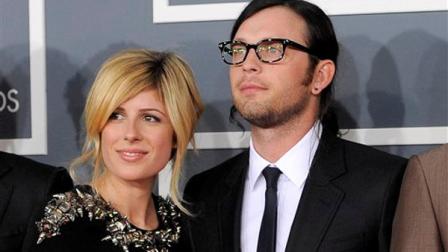 FILE - This Feb. 12, 2012 file photo shows Jessie Baylin with her husband Nathan Followill from The band Kings of Leon at the 54th annual Grammy Awards in Los Angeles. Kings of Leon spokesman Ken Weinstein says the couple are expecting their first child in December. (AP Photo/Chris Pizzello, file)