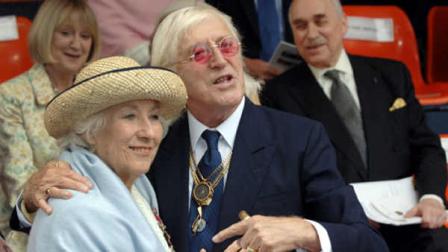 FILE In this Sunday Sept. 18, 2005 file photo Vera Lynn and Jimmy Saville, right are seen at the unveiling of a contemporary sculpture at Victoria Embankment in central London to mark the 65th anniversary of the Battle of Britain. Friends and police say veteran British broadcaster Jimmy Savile, a famously eccentric popular culture figure, has died Saturday Oct. 29, 2011 at his home in northern England. He was 84. Savile, known for his garish tracksuits, chunky gold jewelry and boundless enthusiasm for pop music and charity work, was the host of two long-running British television programs and claimed to have been a confidant to the royal family. (AP Photo/Matthew Fearn, Pool)
