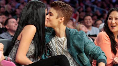 Singer Justin Bieber kisses actress Selena Gomez during the first half of an NBA basketball game as the San Antonio Spurs play the Los Angeles Lakers, Tuesday, April 17, 2012, in Los Angeles. (AP Photo/Jason Redmond)