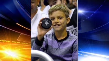 Romeo Beckham, son of soccer player David Beckham, holds up a puck that he was given after it went into the crowd as he watched the Los Angeles Kings play the Phoenix Coyotes in Game 4 of the NHL hockey Stanley Cup Western Conference finals, Sunday, May 20, 2012, in Los Angeles. The Coyotes won 2-0. (AP Photo/Mark J. Terrill)