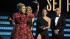 Adele, left, accepts the award for best pop solo...