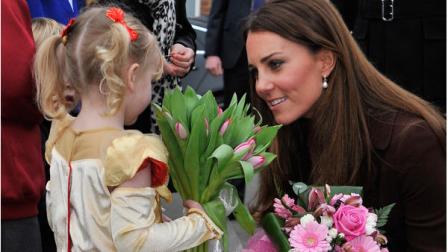 Britains Catherine, Duchess of Cambridge receives flowers from 3-year old Isobelle Laursen during her visit to Humberside Fire and Rescue Station in Grimsby, north Engalnd, Tuesday March 5, 2013. Her Royal Highness met many local people during her visit and people involved in a personal development course run by The Princes Trust and delivered in partnership with Humberside Fire and Rescue Service. (AP Photo / Bruce Adams)