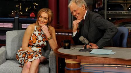 In this Tuesday, April 9, 2013 photo released by CBS Entertainment, actress Lindsay Lohan talks to David Letterman about her upcoming trip to rehab, her guest star roles in the series Anger Management and film Scary Movie 5 and more during the Late Show with David Letterman, (11:35 PM-12:37 AM, ET/PT) on the CBS Television Network, in New York. (AP Photo/CBS Entertainment, Jeffrey R. Staab)