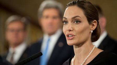 Flanked by G8 Foreign Ministers, US actress Angelina Jolie, in her role as UN envoy, talks during a news conference regarding sexual violence against women in conflict, during the G8 Foreign Ministers meeting in London, Thursday, April, 11, 2013. The ministers are meeting in London as Britain currently holds the G8 Presidency, with the heads of government G8 meeting set for June in Northern Ireland.(AP Photo/Alastair Grant, pool)
