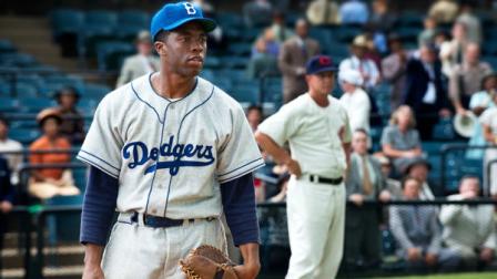 This film image released by Warner Bros. Pictures shows Chadwick Boseman as Jackie Robinson in a scene from 42. The movie, about Robinsons, life, is bringing his inspiring story to a new generation. Fans young and old can find a number of places in Brooklyn connected to the baseball great. (AP Photo/Warner Bros. Pictures, D. Stevens)