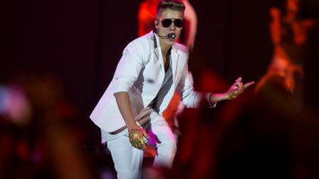 FILE - A Sunday, March 31, 2013 photo from files showing Canadian singer Justin Bieber performing on stage during the I Believe Tour in Berlin, Germany. Swedish police say they have found drugs on board a tour bus used by Canadian pop singer Justin Bieber. Police spokesman Lars Bystrom says a small amount of drugs and a stun gun were found when officers raided the empty bus parked under the Globen concert venue in Stockholm, where Bieber was performing Wednesday, April 24, 2013. (AP Photo/Gero Breloer)