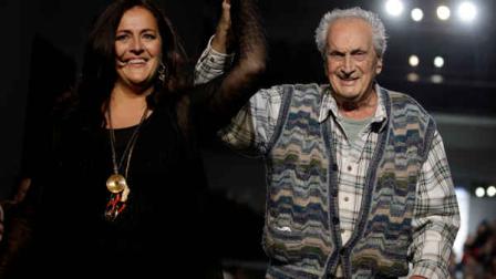 FILE - In this Feb. 27, 2011 file photo Ottavio Missoni, right, and his daughter Angela acknowledge the applause of the audience after presenting their Missoni Fall/Winter 2011 collection, in Milan, Italy. Italian fashion company Missoni says its co-founder, Ottavio Missoni, has died in his home earlier on Thursday, May 9, 2013 in northern Italy. Missoni, who was 92, founded the iconic fashion brand of zigzagged-patterned knitwear along with his wife, Rosita, in 1953. The Missonis are a family fashion dynasty, with the couples children and their offspring involved in expanding the brand. (AP Photo/Luca Bruno, File)