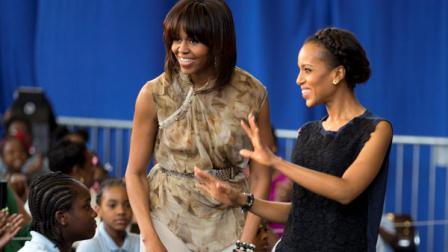 First lady Michelle Obama and actress Kerry Washington smile as they arrive for a performance at Savoy Elementary School in Washington, Friday, May 24, 2013. The Savoy School was one of eight schools selected last year for the Turnaround Arts Initiative at the Presidents Committee on the Arts and Humanities. Turnaround Arts Schools use the arts as a central part of their reform strategy to improve low performing schools (AP Photo/Evan Vucci)