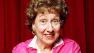 Actress Jean Stapleton stars in an off-Broadway musical  Bon Appetit.  In the show, she sings a Julia Child recipe for Gateau au Chocolat l Eminence Brune, otherwise known as chocolate cake. Photo is undated.