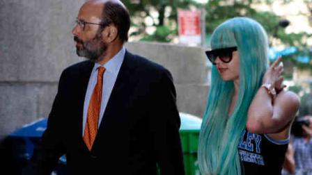 Amanda Bynes, accompanied by attorney Gerald Shargel, arrives for a court appearance in New York, Tuesday, July 9, 2013. The 27-year-old actress is charged with reckless endangerment and attempted tampering with physical evidence. (AP Photo/Bethan McKernan)