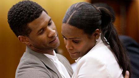 R&B singer Usher, left, embraces ex-wife Tameka Foster Raymond, after a judge dismissed an emergency request by Raymond seeking temporary custody of their two children, Friday, Aug. 9, 2013, in Atlanta. Raymond had requested the hearing earlier this week after their 5-year-old son got caught in a pool drain while in the care of the Grammy winners aunt. After a hearing in which both Usher and Raymond took the stand, Fulton County Superior Court Judge John Goger dismissed her request for temporary primary custody and decision-making authority. (AP Photo/David Goldman)