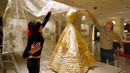 Marshall Fields workers Mara Cohn and Daniel Pionke affix the veil on a paper replica of the wedding dress Jacqueline Bouvier wore on her wedding day to John F. Kennedy as they prepare the dress for display Wednesday, Jan. 12, 2005, at the downtown Chicago store. The exhibit is in connection with a showing of her clothing, Jacqueline Kennedy: The White House Years, currently on display at Chicagos Field Museum. Two artists created the dress that will be donated in April to the John F. Kennedy Library and Museum, where the original gown cannot be exhibited because of its fragile state. (AP Photo/Nam Y. Huh)