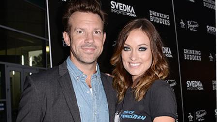 FILE - In this Thursday, Aug. 15, 2013 file photo, actor Jason Sudeikis and actress Olivia Wilde, arrive on the red carpet at the special screening of the feature film Drinking Buddies at the ArcLight Hollywood, in Los Angeles. Fashionista Wilde and her comedic fiance Sudeikis, have been engaged since very early this year but have yet to spill details about their wedding plans--theyre too busy. Wilde, who has released two films with one more pending in 2013, spoke to the Associated Press about simply enjoying being engaged, her latest indie comedy, Drinking Buddies, and addressed rumors she may return for another Tron. (Photo by Dan Steinberg/Invision/AP, File)