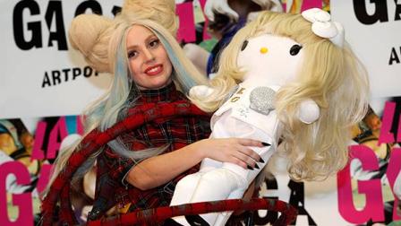 Lady Gaga poses for photographers with a Hello Kitty doll during a press conference to promote her album ARTPOP in Tokyo, Sunday, Dec. 1, 2013. The doll will be sold at an auction for donation to the northeastern Japanese regions hit by the 2011 earthquake and tsunami. (AP Photo/Shizuo Kambayashi)