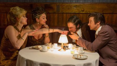 In this photo released by Sony Pictures, from left, Jennifer Lawrence, as Rosalyn Rosenfeld, insists on smelling her nail polish, Elisabeth Rohm as Dolly Polito, Christian Bale as Irving Rosenfeld and Jeremy Renner as Mayor Carmine Polito oblige inside Barons Restaurant in Columbia Pictures American Hustle. In the movie, which opened Friday, Dec. 20, 2013, Renners character goes corrupt as a means to help his city and state. (AP Photo/Sony - Columbia Pictures, Francois Duhamel)