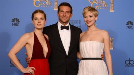 From left, Amy Adams, Bradley Cooper, and Jennifer Lawrence, winners of the award for best motion picture - comedy or musical for American Hustle pose in the press room at the 71st annual Golden Globe Awards at the Beverly Hilton Hotel on Sunday, Jan. 12, 2014, in Beverly Hills, Calif. (Photo by Jordan Strauss/Invision/AP)