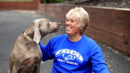 In this Friday, May 13, 2011 picture, Karen Cornwall plays with her dogs Bel, left, and Mac, in front of her home in Havertown Pa. Cornwall, a nurse who played a slew of sports since childhood, had both knees replaced last year when she was 54. Dr. Nicholas DiNubile, an adviser to several pro athletic groups and a spokesman for the American Academy of Orthopaedic Surgeons, says The boomers are the first generation trying to stay active in droves on an aging frame and are less willing to use a cane or put up with pain or stiffness as their grandparents did.