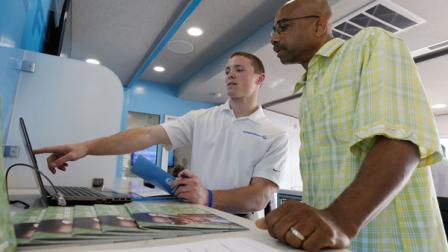 David Smith, center, with Independence Blue Cross (IBC) discuses the opening health insurance exchange and provides information on health car reform to George Allen Tuesday, Oct. 1, 2013, at IBCs mobile education and enrollment center in Philadelphia. (AP Photo/Matt Rourke)