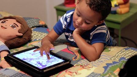 In this Friday, Oct. 21, 2011 photo, Frankie Thevenot, 3, plays with an iPad in his bedroom at his home in Metairie, La.