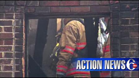 Firefighters walk through the burned out hulk of some units in the Woodcrest Apartments in Dover, Delaware, after a deadly fire Sunday morning.