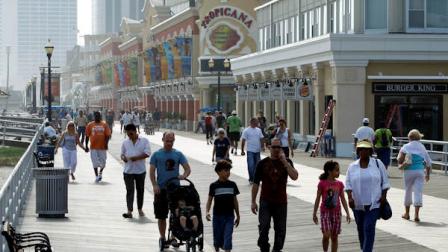 FILE - This Sept. 2, 2010 file photo shows people walking along the boardwalk in Atlantic City, N.J. (AP Photo/Matt Rourke, file)