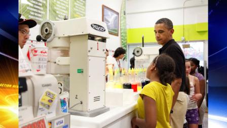 President Barack Obama looks to his daughter Sasha Obama a he orders shave ice at Island Snow at Kailua Beach Center while on vacation with the first family in Kailua, Hawaii, Monday, Dec. 27, 2010. (AP Photo/Carolyn Kaster)