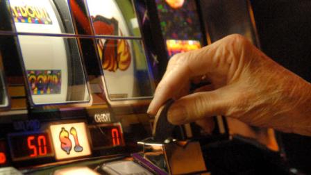 FILE - In this April 1, 2009 file photo, a player puts a dollar coin in one of Resorts Atlantic Citys dollar-coin slot machines in Atlantic City, N.J. The amount of time gamblers in the nations second-largest casino market are spending in Atlantic City casinos is falling, and theyre holding on more tightly to their wallets while theyre there. A new statistical study shows the amount of time gamblers spent inside the gambling halls is down more than 22 percent, and the amount of money they spend there is down almost 30 percent over the last four years.