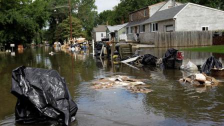 Waterlogged furniture sits on along Riverside Drive as a trash bag floats in floodwaters in Wayne, N.J., where the Passaic River has overflowed its banks and reached a community for the fourth time in six months following a storm, Thursday, Sept. 8, 2011. Residents along the Passaic River are still cleaning up after Irene with the remnants of Lee expected to drop anywhere from two to five inches of rain. Forecasters say New Jerseys streams and rivers remain at or in flood stage.