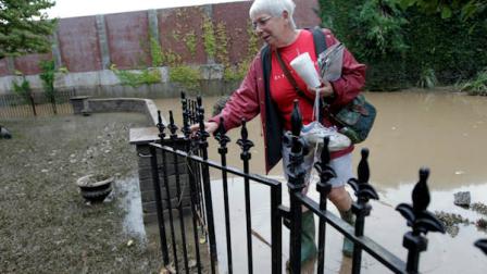 Ellie Martindale, one of the first residents to return, walks in her gate to check on her home after flooding in the Shipoke area caused by the remnants of Tropical Storm Lee Saturday, Sept. 10, 2011 in Harrisburg, Pa. (AP Photo/Alex Brandon)