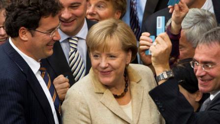 German Chancellor Angela Merkel reacts after she casts her vote about the eurozone bailout fund at the German parliament Bundestag in Berlin, Thursday, Sept. 29, 2011. German lawmakers are expected to approve new powers Thursday for the eurozone bailout fund in a major step toward tackling the blocs sprawling sovereign debt crisis.