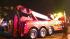A tow truck arrives on the scene to recover the...