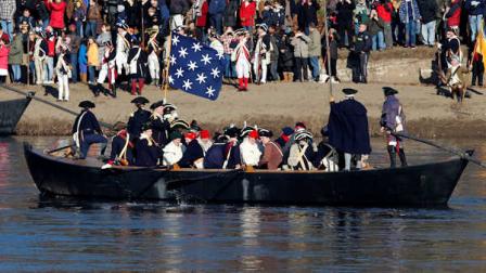 The boat with Gen. George Washington in it, nears New Jersey during the 59th reenactment of Washington crossing the Delaware River Christmas Sunday, Dec. 25, 2011, in Washington Crossing, Pa. Over 168 re-enactors participated in the event. (AP Photo/Alex Brandon)