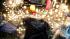 Candles, flowers, notes and other mementos are...