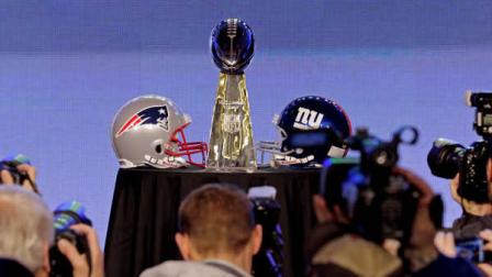 Photographers take pictures of the Vince Lombardi Trophy before a news conference for NFL footballs Super Bowl XLVI Friday, Feb. 3, 2012, in Indianapolis. (AP Photo/Charlie Riedel)