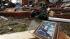 A photo and other remains scatter in front of a...