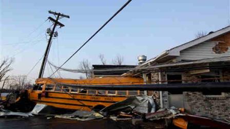 A school bus is pushed through the front of a building after a tornado swept through Henryville, Ind., Friday March 2, 2012. The storm was part of a system that brought high winds and heavy rain to parts of Indiana, Kentucky and Tennessee. (AP Photo/Philip Scott Andrews)