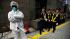 A costumed protester stands outside a Tokyo...