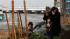 A family offers prayers at a makeshift shrine in...