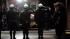 Police officers salute as the remains of fallen...