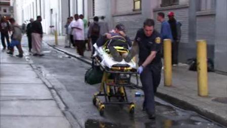 Medics transport a man who police say was assaulted on a Center City street on Monday, June 4, 2012.