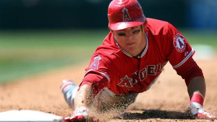 Los Angeles Angels Mike Trout dives safely back to first to beat the tag by the Colorado Rockies during the fifth inning of an interleague baseball game on Sunday, June 10, 2012, in Denver. (AP Photo/Jack Dempsey)