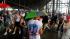 Fans stand under the grandstand after the start...