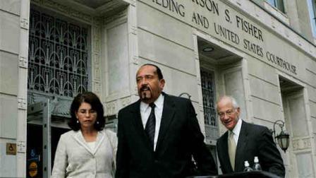 FILE - In this July 24, 2009 file photograph, former New Jersey Sen. Wayne Bryant, center, walks with his wife Cheryl Spicer and his lawyer Carl Poplar as they leave federal court following Bryants sentencing in Trenton, N.J. Bryant was sentenced to 4 years in prison for bribery and fraud after being convicted of being paid for a job that required no work at a state university in exchange for securing state funding for it. The once powerful Camden County Democrat is due to report Tuesday, Aug. 25, 2009, to a federal prison in West Virginia. (AP Photo/Mel Evans,file)