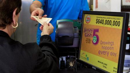 A person buys a lottery ticket at the Lucky 7 Deli in Lawrence Township, N.J., Friday, March 30, 2012. Lottery ticket lines across the U.S. swelled Friday as players drawn by a record $640 million Mega Millions jackpot took a chance at becoming an overnight millionaire. The jackpot odds were at 1 in 176 million. (AP Photo/Mel Evans)