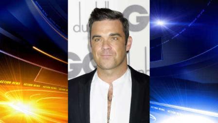 Robbie Williams arrives for the GQ Men of the Year Awards at a central London venue, Tuesday, Sept. 4, 2012. (AP Photo/Jonathan Short)