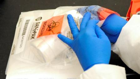 Laboratory technician Ruth Rutledge packages cerebrospinal fluid of the three confirmed meningitis cases in Minn., to send to the Centers for Disease Control and Prevention in Atlanta for further testing, at the Minnesota Department of Health in St. Paul, Minn., on Tuesday, Oct. 9, 2012. The number of people sickened by a deadly meningitis outbreak has now reached 119 cases, including 11 deaths, according to the CDC. The states involved in the outbreak are Tennessee, Michigan, Virginia, Indiana, Florida, Maryland, Minnesota, North Carolina, New Jersey and Ohio. Officials have tied the outbreak of rare fungal meningitis to steroid shots for back pain. (AP Photo/Hannah Foslien)