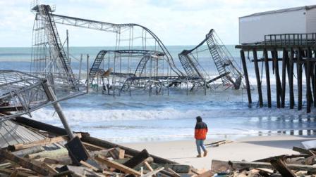 A man looks over the debris on the Seaside Heights, N.J., beach near Casino Pier on Wednesday, Oct. 31, 2012. (AP Photo/Star-Ledger, David Gard/POOL)