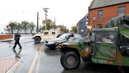 National guard and police block a flooded street in downtown Annapolis Md, Tuesday, Oct. 30, 2012, after superstorm Sandy passed over the area. Crews are still working to restore power to hundreds of thousands in Maryland, Delaware, the District of Columbia and northern Virginia after winds from Sandy downed trees and power lines. (AP Photo/Jose Luis Magana)