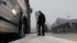 As a steady snow falls, a commuter boards a bus...